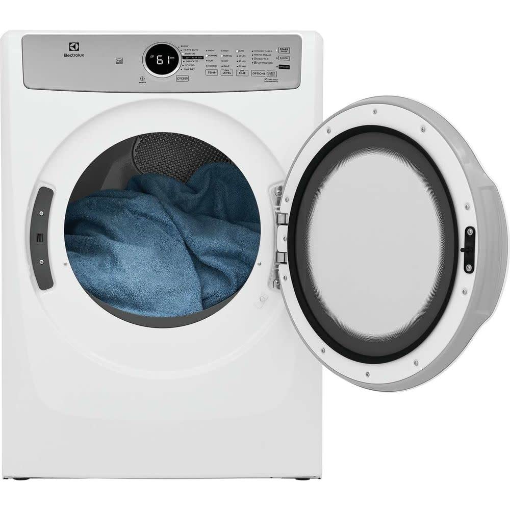 Professional washer repair technician servicing a front load washing machine in The Woodlands TX home - Same Day Washer Repair Service